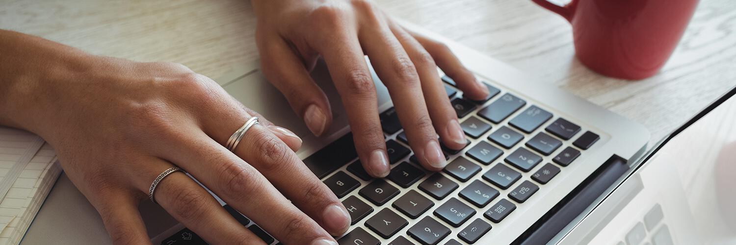 hands typing on keyboard